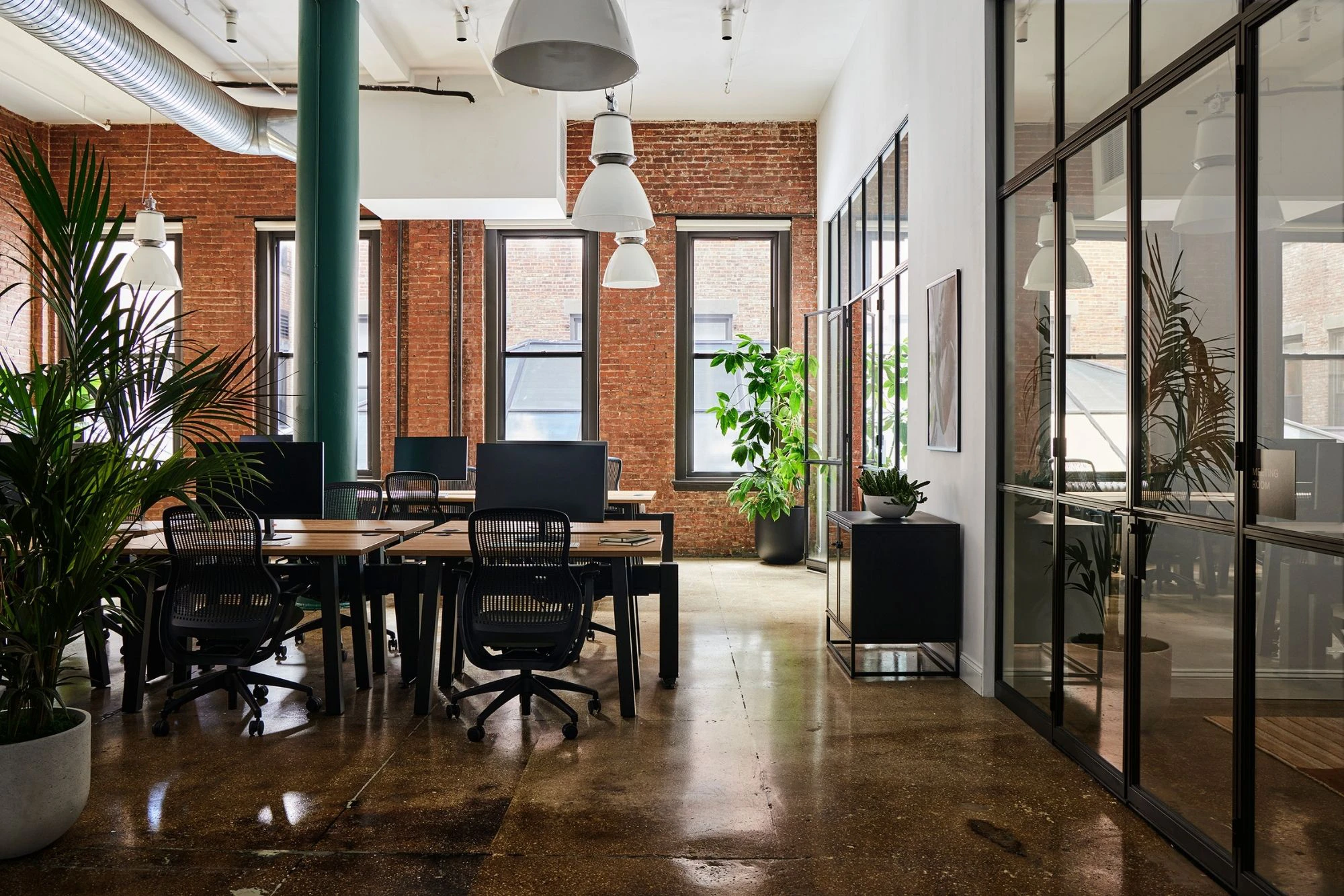 commercial office space design with open concept, brick walls and glass doors