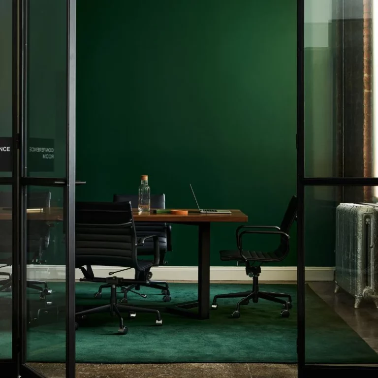 commercial office space design with green walls and glass doors