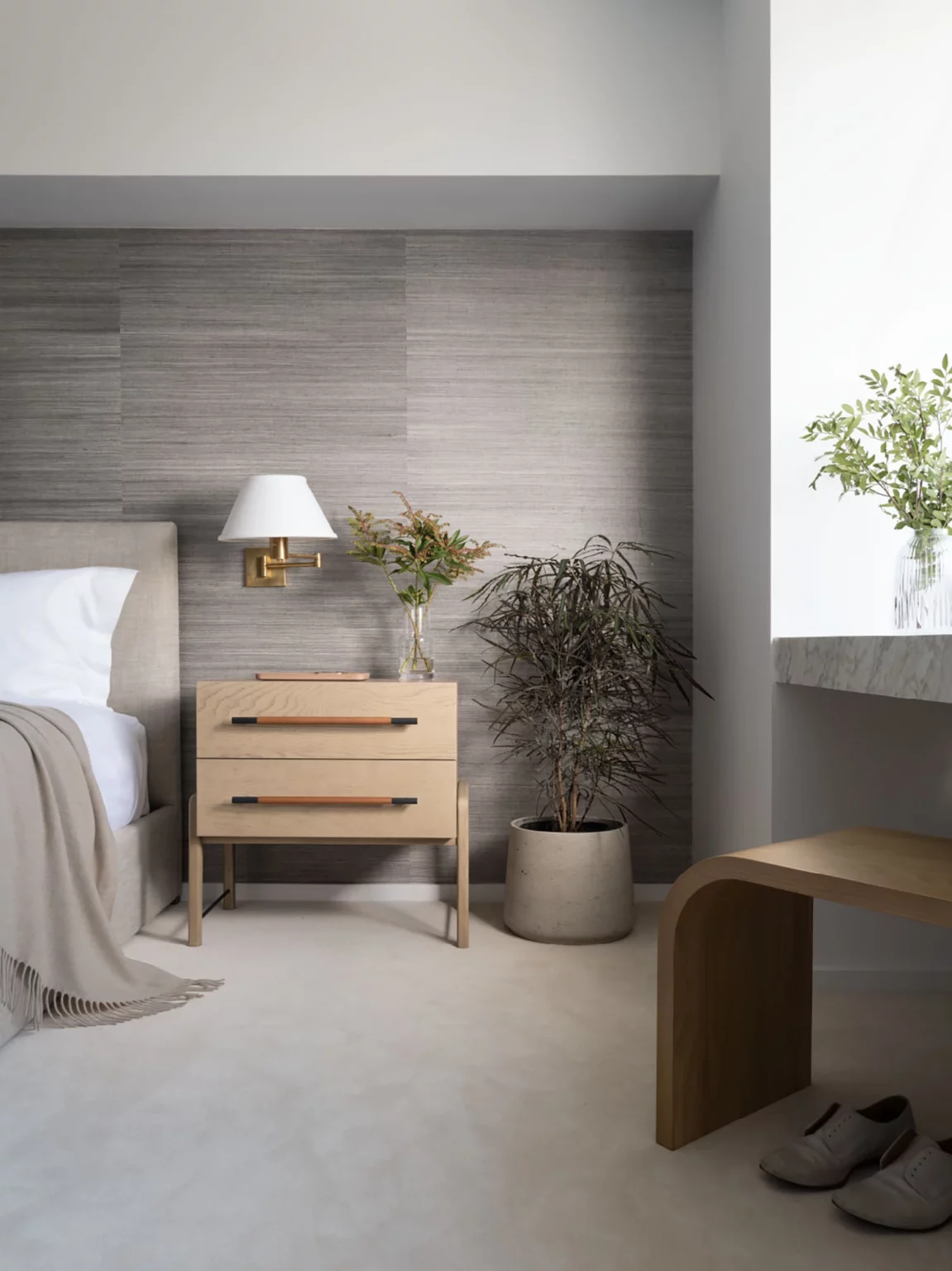 bedroom with grey wall paper and natural color night stand